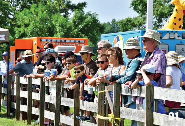 spectators line the fence