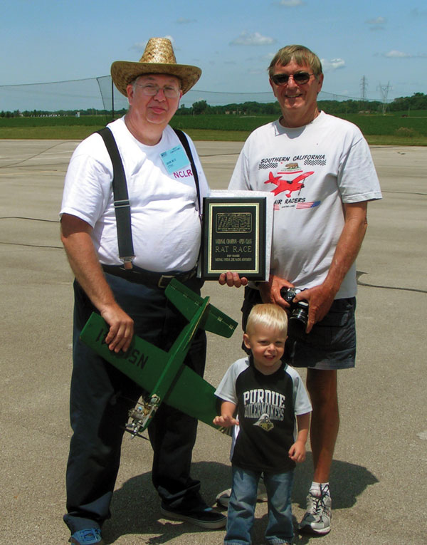 CL Racing Rat Race winner David Betz poses with his grandson, Christphor DeGraff, and pilot, Charlie Johnson.