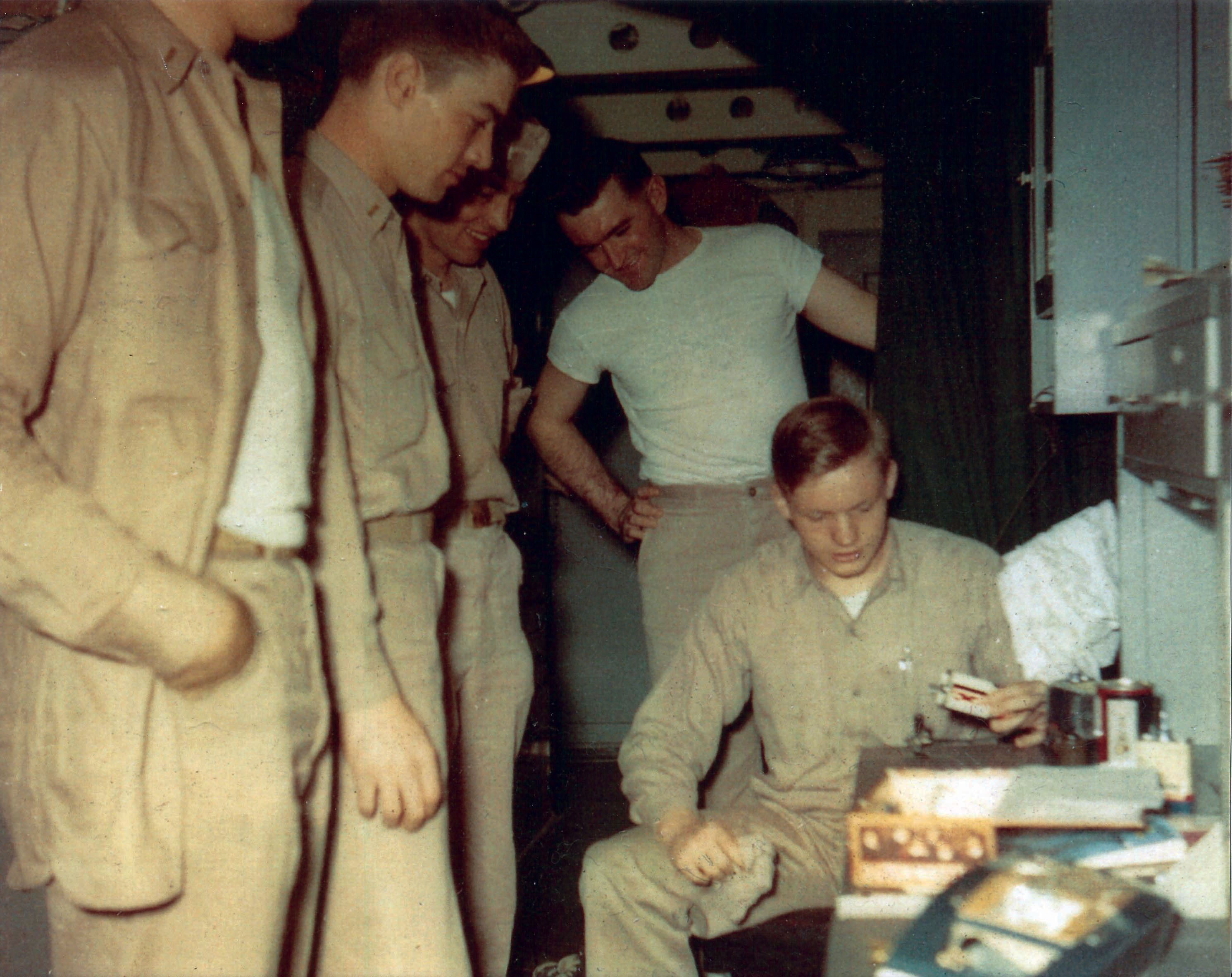 neil demonstrates aeromodeling techniques to his fellow squadron pilots aboard the uss essex during the korean war