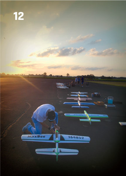 Mike Scott worked on his airplane at dawn during the CL Precision Aerobatics Nats contest. Neumann photo.