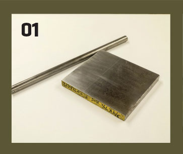 01. The basic materials are an approximate 7-inch square block of 3/4-inch cold-rolled steel (CRS) and a roughly 16-inch length of 3/4-inch round CRS bar stock. These were purchased at a local scrap yard for less than $15. 