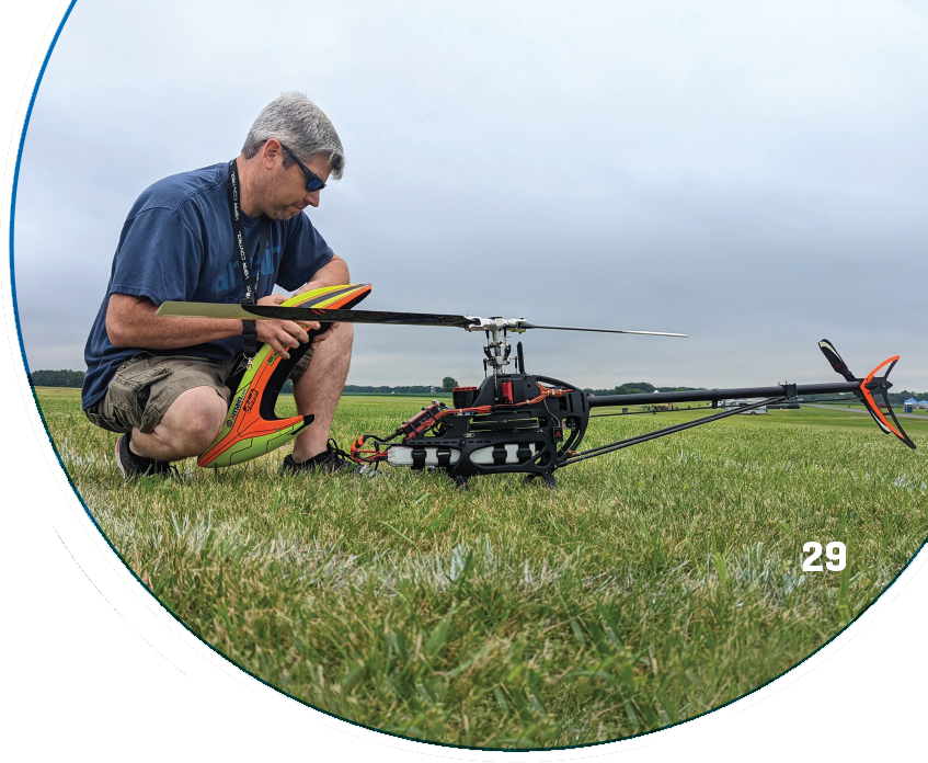 An RC Helicopter Nats pilot inspects his aircraft before flight. Photo by Michael Parker.
