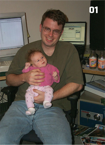 Scott is shown in 2000, programming RealFlight with his daughter on his lap. 