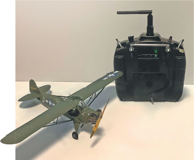 The author tested the module with his Spektrum DX8 transmitter and 1/35-scale Piper L-4 model that uses a Grasshopper receiver. He mounted the module on the back of his transmitter with double-sided tape. 