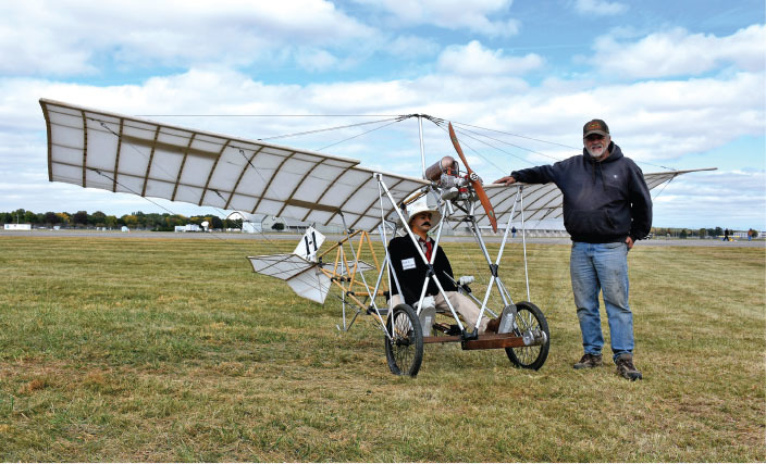Peter admires Gary Denzler’s full-scale Demoiselle model, which spans 17 feet and is controlled by three channels. 