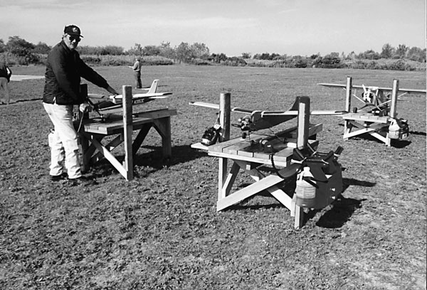 Here are several benches in use at the Meroke club’s Long Island field. Robert Meyer prepares his RC sport model for a flight. 