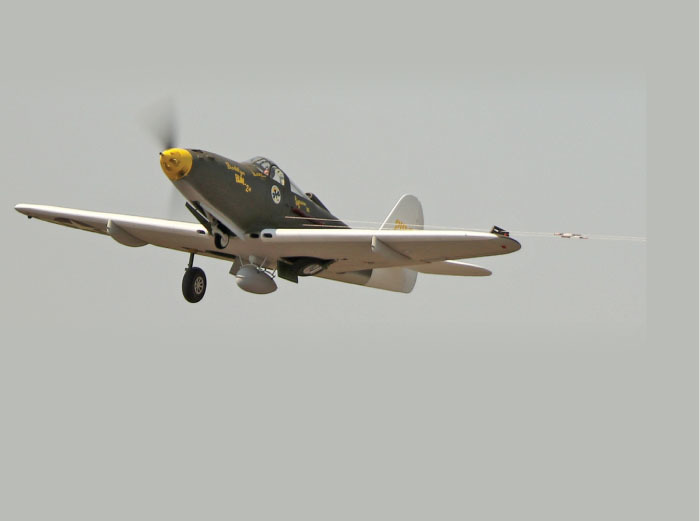 Steve’s P-39 is shown in flight with the gear coming up. The model used 2.4 GHz power for the flaps, drop tank, retractable landing gear, and electric motor control. 