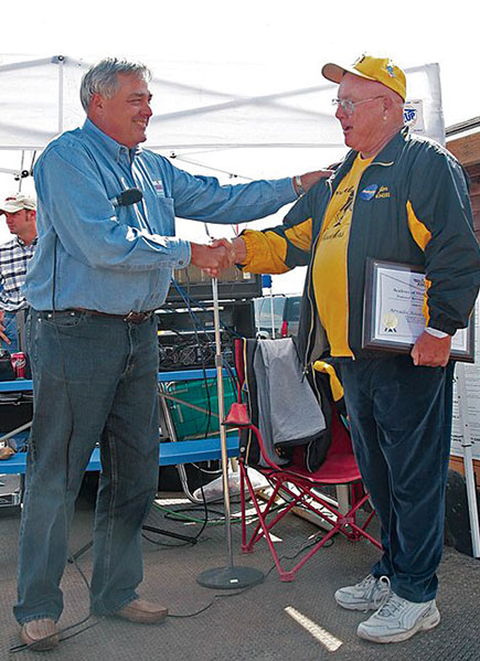 AMA District IX Vice President Mark Smith (L) presents Jim Wallen with an award for outstanding achievement from the Arvada Associated Modelers.