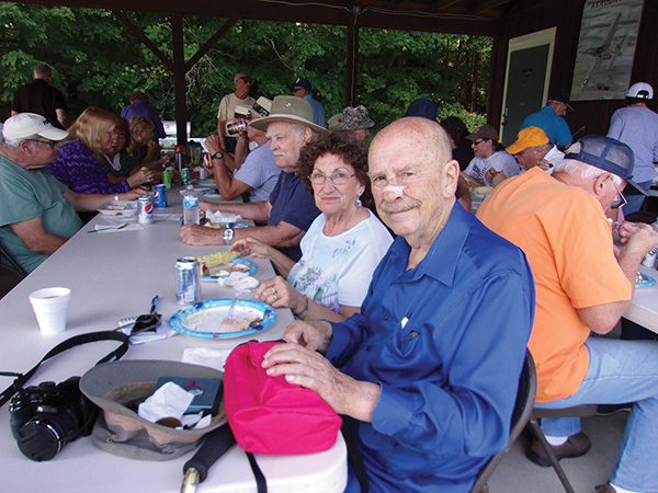 Members and friends eat under the pavilion while attending the STARS Open House at the end of August 2021.