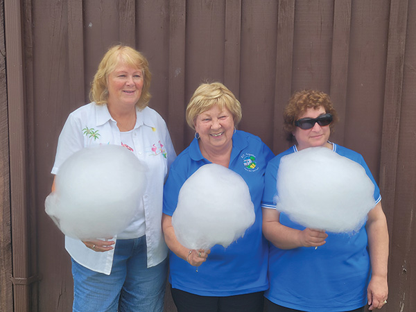  (L-R) Judy Hazzard, Judy Lander, and Shirley Brierley, wives of STARS members are getting ready to enjoy cotton candy at the STARS’ annual fun-fly that was held in July 2021.