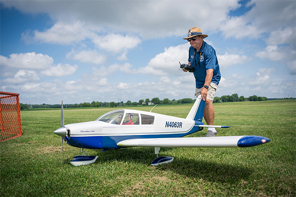 AMA District III vice president Mark Radcliff escorts his Cherokee 140 from the flightline during the RC Scale competition.