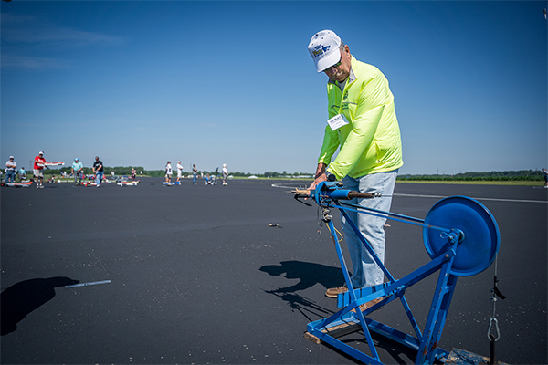 Mark Weiss assists in a pull test prior to a flight