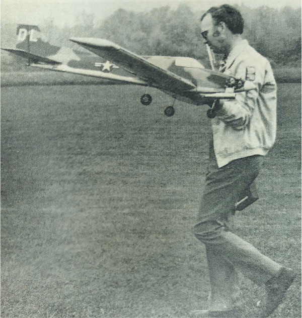 Don Lowe is shown with his Phoenix 5 aircraft that featured a unique camouflage paint scheme. 