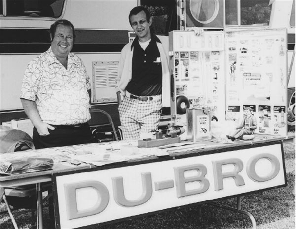 Dewey Broberg (L) and David Gray show off their products at a flying event.