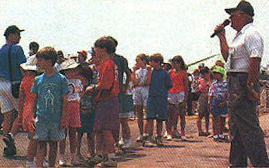 Flight line director Bob Underwood gathering all the kids while Ed Henry and Eric Dern readied the candy bombers.