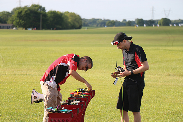 chris thomas the multigp founder inspects quadcopters