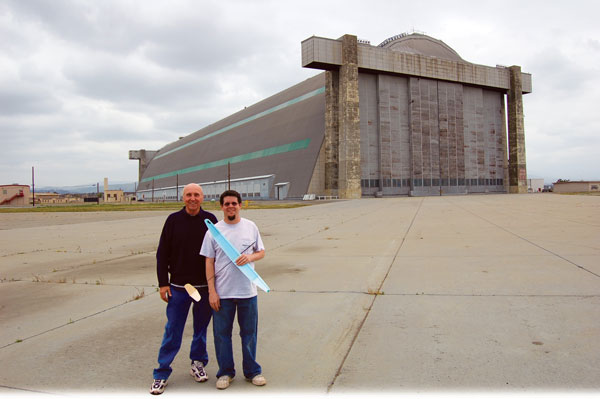 Ron Wittman (L) stands in front of the Tustin Blimp Hangar with the author, who holds the model he used to break Ron’s 35-year-old Indoor Glider records in the fall of 2009.