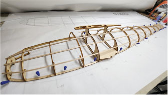 The fuselage is built in two halves on the plans. Care must be taken to identify the tops of the ribs because they are not symmetrical. 