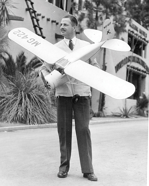 reg holds his dennyplane at the motion picture hall of fame