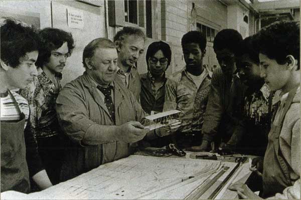Howard Kelem shows August Martin High School students a Wright Flyer Scale model. They helped build the full-scale replica.