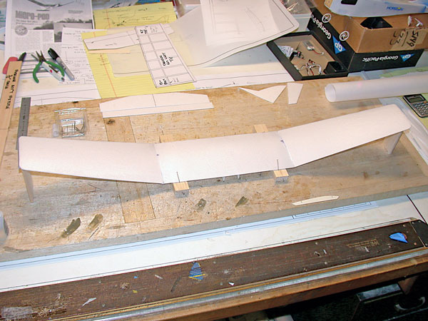 Airfoil curvature on wing panels results from rolling foam pieces over a large-diameter length of PVC pipe. The outer wing panels have carbon-fiber strips at the point of maximum camber. Polyhedral is added to both wingtip panels; the center-section is fl