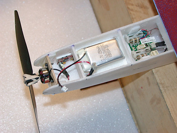 The complete power and RC system is forward of the wing LE with motor installed. An ESC is taped to the side; its wires run under the battery tray. The ParkZone AR6400 brick contains receiver and servos.