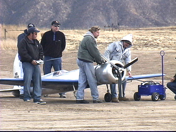On the flightline (L-R), Jason Somes, Darrel Hoffman, Adam Gelbart, Joe Bock, and John Keefe prepare to start the H-1 race airplane.