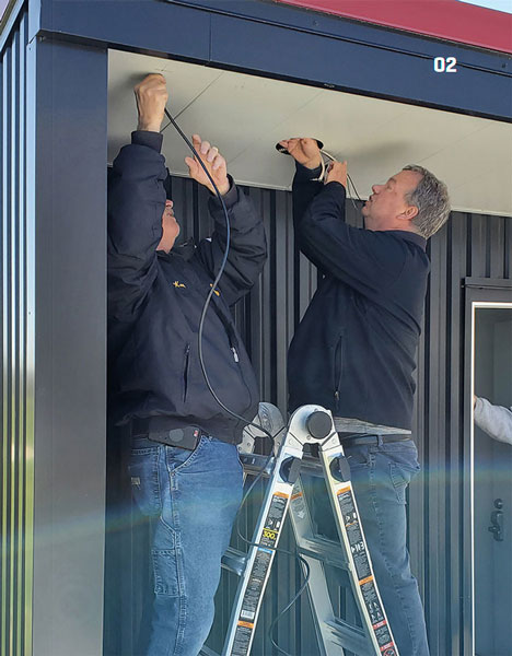  Kevin Hyde and Dan Fitzgerald install a webcam on a shed at the Omahawks field. 